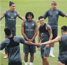  ?? Reuters ?? Mesut Ozil, centre right, trains in Singapore ahead of Arsenal’s pre-season friendly against Athletico Madrid