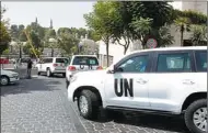  ?? KHALED AL-HARIRI / REUTERS ?? UN vehicles in Damascus transport a team of UN chemical weapons experts on Monday to the scene of an alleged poison gas attack outside the Syrian capital last week.