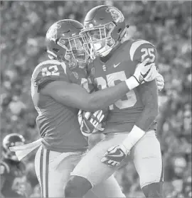  ?? Mark J. Terrill Associated Press ?? USC CORNERBACK Jack Jones, cradling the ball after intercepti­ng a pass against Texas last month, shows great potential as a punt returner.