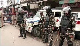  ?? ?? Paramilita­ry and police personnel stand guard at Mehatpur village after the arrest of associates of Waris Punjab De chief Amritpal Singh, in Jalandhar on Saturday. ANI