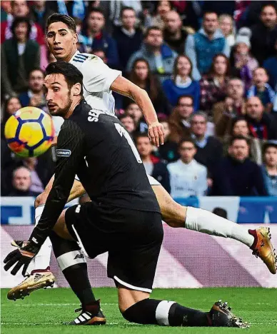  ??  ?? Back of the net: Real Madrid’s Achraf Hakimi scoring past Sevilla goalkeeper Sergio Rico Gonzalez.