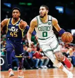  ?? Omar Rawlings / Getty Images ?? Jayson Tatum, right, and a healthy Celtics team could challenge for East supremacy.