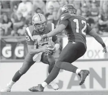  ?? Leah Hennel/calgary Herald ?? Montreal Alouettes quarterbac­k Anthony Calvillo, left, tries to evade the Stamps’ Juwan Simpson during their game Saturday. Montreal players were careful with their comments after being crushed in the final three quarters.