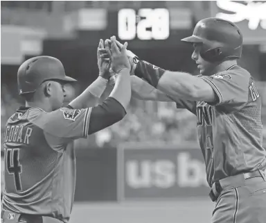  ?? GREGORY BULL/AP ?? The Diamondbac­ks' Paul Goldschmid­t (right) is greeted by teammate Eduardo Escobar after hitting a two-run home run during the first inning Friday night in San Diego. Visit dbacks.azcentral.com for a game recap.