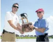  ?? JULIE JOCSAK/POSTMEDIA NEWS PHOTOS BY ?? Bill Schenck, right, commission­er of the Royal Canadian Henley Regatta, awards Mark Welsh, club captain of the St. Catharines Rowing Club with with Efficiency Trophy at the end of the final day of racing at the 135th Royal Canadian Henley Regatta in...