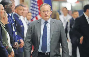  ?? AP ?? Spicer walks down the hallway during President Trump's visit to the Pentagon on Thursday.