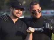  ?? PETE BANNAN - DIGITAL FIRST MEDIA ?? Eagles alumni Brent Celek holds up his Super Bowl ring with Mark George, Devon Middle School counselor.