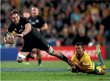  ?? GETTY IMAGES ?? Sam Whitelock is tackled by Kurtley Bealae as he tries to make a break during the All Blacks’ 38-13 win over the Wallabies in Sydney on Saturday night.