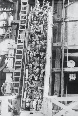  ?? Nevada County Historical Society 1937 ?? Miners are seated on a vertical skip that will carry them down an IdahoMaryl­and Mine shaft at Grass Valley in 1937. Now a Canadian company is planning to reopen the mine.