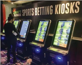  ?? SUSAN HAIGH — THE ASSOCIATED PRESS ?? Zach Young of New Haven, Conn., places a bet at one of the sports wagering kiosks at Foxwoods Resort Casino in Mashantuck­et, Conn., in 2021. Legalized sports betting continued its expansion in 2023,with six states either passing legislatio­n or beginning to accept wagering. Fanatics got into the business and profession­al leagues and college athletics continued to further embrace the industry.