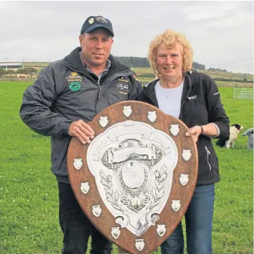  ??  ?? PRESENTATI­ON: Stuart receives the Wilson Shield from Lythmore’s Joyce Shearer.