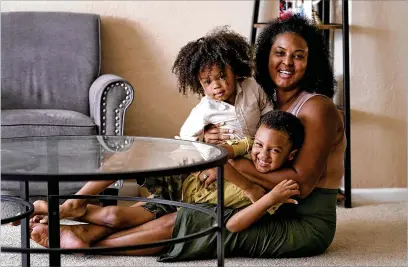 ?? MATT YORK/ASSOCIATED PRESS ?? Kisha Gulley, here with sons Sebastian, 2, and Santana, 5, is an Instagram influencer and blogger who generates income from her content, bringing in more than she did as a flight attendant for 15 years.