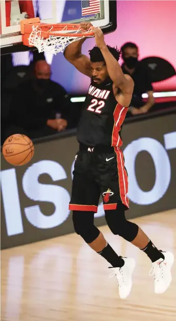  ?? GETTY IMAGES ?? Jimmy Butler dunks for two of his 17 points in the fourth quarter, in which the Heat outscored the Bucks 40-13.