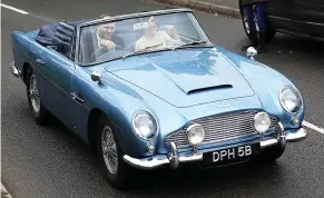  ??  ?? Transport of delight: The couple in Chris Evans’s Aston Martin