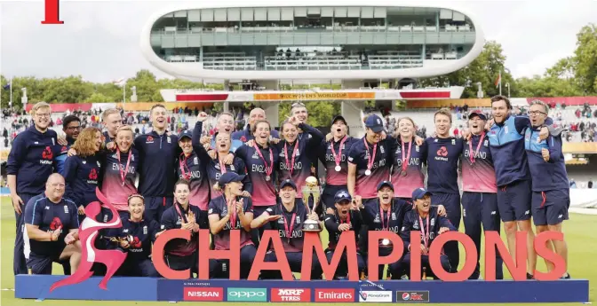  ?? — AFP ?? LONDON: England players pose with the trophy after winning the ICC Women’s World Cup cricket final between England and India at Lord’s cricket ground in London yesterday.