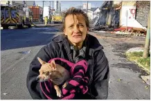  ??  ?? Like many residents near the Food For Less on East Third Street destroyed by fire Thursday, Barbara Hamrick, 43, said she will now have to take a bus to get groceries instead of taking a short walk.