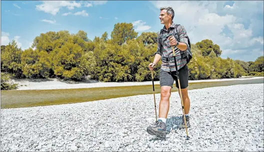  ?? GETTY ?? Walking poles can help take some stress off the knees, researcher­s found.