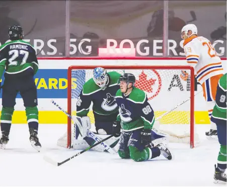  ?? BOB FRID/USA TODAY SPORTS ?? Canucks goalie Thatcher Demko and defenceman Nate Schmidt are both literally and figurative­ly on their knees after falling behind to the Oilers in the second period of Thursday night's NHL game at Rogers Arena. Edmonton blanked the home side 3-0.