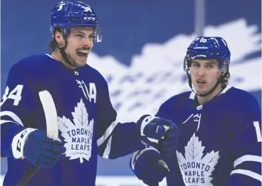  ?? NATHAN DENETTE / THE CANADIAN PRESS ?? Leafs centre Auston Matthews celebrates his first-period power play goal against the Ottawa Senators with teammate Mitch Marner Thursday at Scotiabank Arena.