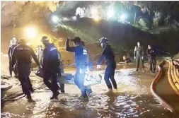  ?? AP ?? Photo shows rescuers holding an evacuated boy inside the Tham Luang Nang Non cave in northern Thailand on Tuesday.