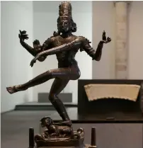  ??  ?? A dancing Shiva statue is displayed in the section dedicated to the story of world religions, amid other religious relics.