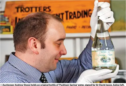  ?? SWNS/BBC ?? Auctioneer Andrew Stowe holds an original bottle of ‘Peckham Spring’ water, signed by Sir David Jason, below left. Twenty million people tuned in on Christmas Day 1992 to watch this episode, below right