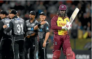  ?? PHOTOSPORT ?? Chris Gayle heads back to the dressing room as Trent Boult smiles in the background