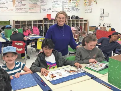  ?? RAINA HANNA / SPECIAL TO DESOTO APPEAL ?? Center Hill Elementary School Principal Leslie Heyman couldn’t help but smile at some of Molly Gates’ third-grade students’ explaining their PTO Boostertho­n “Hat Day” choices. Heyman was named DeSoto County School’s 2017 Administra­tor of the Year.