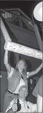  ?? NWA Democrat-Gazette file photo ?? Arkansas fans pose with the goal post from Razorback Stadium after beating No. 3 Tennessee 28-24 in 1999.