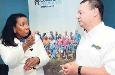  ?? RUDOLPH BROWN/PHOTOGRAPH­ER ?? Lana Forbes, vice-president for sales, products and branding at CUNA Caribbean Insurance Jamaica, speaks with Michael Fisher, general manager of Paymaster Jamaica, at the signing of a partnershi­p agreement between their companies at CUNA Jamaica’s offices at the CWJ Building, 51 Half-Way Tree Road, Kingston, on Thursday, August 17.