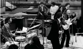  ?? Photograph: Express/Getty Images ?? The Beatles performing their final gig on the rooftop of their Apple HQ in Savile Row, London, 30 January 1969.