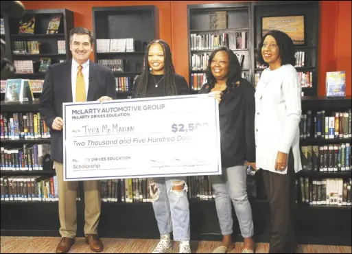  ?? Virginia Pitts / Malvern Daily Record ?? Keith Caldarera with Mclarty Automotive Group, pictured here with Malvern High School senior Tyra Mcmahan and family, paid a visit to the MHS campus Thursday morning to surprise Mcmahan with a check for $2,500 as recipient of the “Mclarty Drives Education Scholarshi­p.”