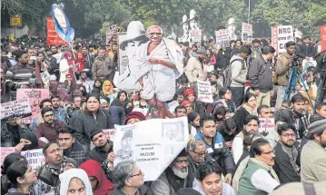  ?? BLOOMBERG ?? Demonstrat­ors march during a protest against a new citizenshi­p law in New Delhi, India, on Tuesday. The Indian government is struggling to contain growing nationwide protests.