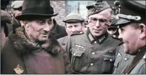  ??  ?? Facing death: A man in the occupied Polish town talks with Nazi officers