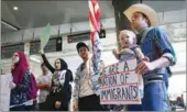  ?? MONICA ALMEIDA / REUTERS ?? People gather to protest against US President Donald Trump’s executive order travel ban at Los Angeles Internatio­nal Airport on Tuesday.