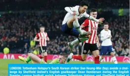  ??  ?? LONDON: Tottenham Hotspur’s South Korean striker Son Heung-Min (top) avoids a challenge by Sheffield United’s English goalkeeper Dean Henderson during the English Premier League football match between Tottenham Hotspur and Sheffield United at Tottenham Hotspur Stadium in London, yesterday. — AFP