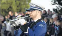  ?? PHOTO: STEPHEN JAQUIERY ?? Tribute . . . Kaikorai Metropolit­an Brass cornettist Mat Patchett plays Last Post and Reveille while posies were laid on the graves of fallen soldiers at the Andersons Bay Cemetery yesterday.