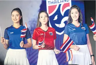  ??  ?? Models sport Thailand’s new T-shirts for cheering fans.