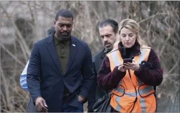  ?? LUCY SCHALY — PITTSBURGH POST-GAZETTE VIA AP ?? Environmen­tal Protection Agency Administra­tor Michael Regan, left, walks with his staff in East Palestine, Ohio, on Thursday.