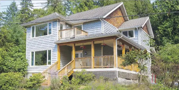  ??  ?? 483 Braewood Place on Bowen Island is a four-bedroom, four-bathroom home with wraparound veranda that sold for $1,248,500.