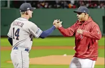  ?? DAVID J. PHILLIP/AP PHOTO ?? Astros manager AJ Hinch and Red Sox manager Alex Cora shake Hanes prior to the start of Game 1 of the ALCS on Saturday night at Fenway Park. The game ended too late for this edition. For a complete recap visit www.theday.com