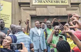  ?? Photo: Felix Dlangamand­la/gallo Images/netwerk 24/Beeld ?? Political chess: Supra Mahumapelo (blue suit) and supporters outside court.