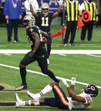  ?? Getty IMaGes; BeloW, aP ?? WHO DAT? New Orleans’ Latavius Murray celebrates after scoring a 6-yard TD during the third quarter as the Saints defeated the Chicago Bears, 21-9, Sunday, Below, Michael Thomas pulls in a pass over Chicago Bears cornerback Kyle Fuller.