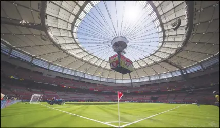  ?? CP PHOTO ?? Water is sprayed on the artificial turf before Switzerlan­d and Ecuador play a FIFA Women’s World Cup soccer match at B.C. Place stadium in Vancouver, B.C., on June 12, 2015.