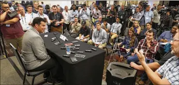  ?? ASSOCIATED PRESS ?? Ohio State head coach Ryan Day (left) talks to reporters during the Big Ten Conference college football media day Thursday, July 18, in Chicago. Day has seven in-state recruits verbally committed for the Class of 2020.