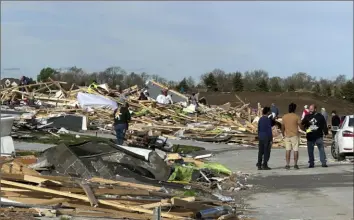  ?? Nicholas Ingram/Associated Press ?? A tornado leveled houses Friday night in the Omaha, Neb., neighborho­od of Elkhorn. Here, Elkhorn residents search through the rubble on Saturday. No deaths had been reported.