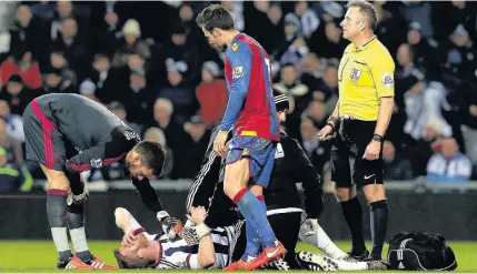  ??  ?? > Chris Brunt is treated on the pitch against Crystal Palace after suffering knee ligament damage.