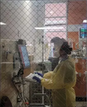  ?? (Special to the Arkansas Democrat-Gazette) ?? Nurse Tiffany Dahl logs a patient’s chart in the ICU at St. Bernards Healthcare in Jonesboro.