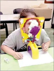  ?? PHOTO SUBMITTED ?? Sarah Newburn,11, at the moment a pie in the face lands squarely on her nose while playing a game during McDonald County Library’s Teen Night.