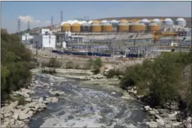  ?? REBECCA BLACKWELL — THE ASSOCIATED PRESS ?? A river of untreated sewage flows past the $530 million wastewater treatment plant in Atotonilco de Tula, Hidalgo state, Mexico. After years of delays, the plant, billed as the largest of its kind in Latin America, is in its testing phase and expected...